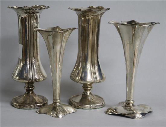 A pair of Edwardian silver spill vases and two smaller similar, 17.2cm.